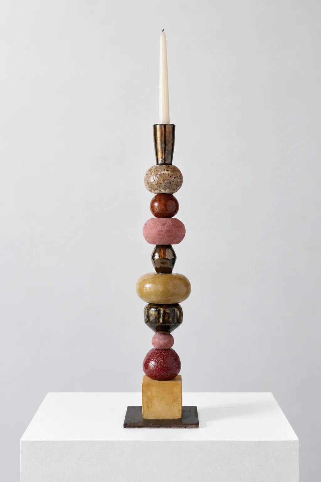Shamadan No. 2 by Minaal Lawn, a ceramic candlestick of stacked glazed forms on a steel base